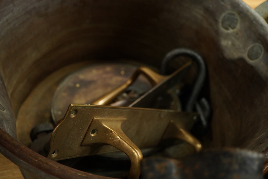 A collection of metalware to include a Victorian copper pan, a figural cast iron doorstop- 39cm high, brass door handles etc